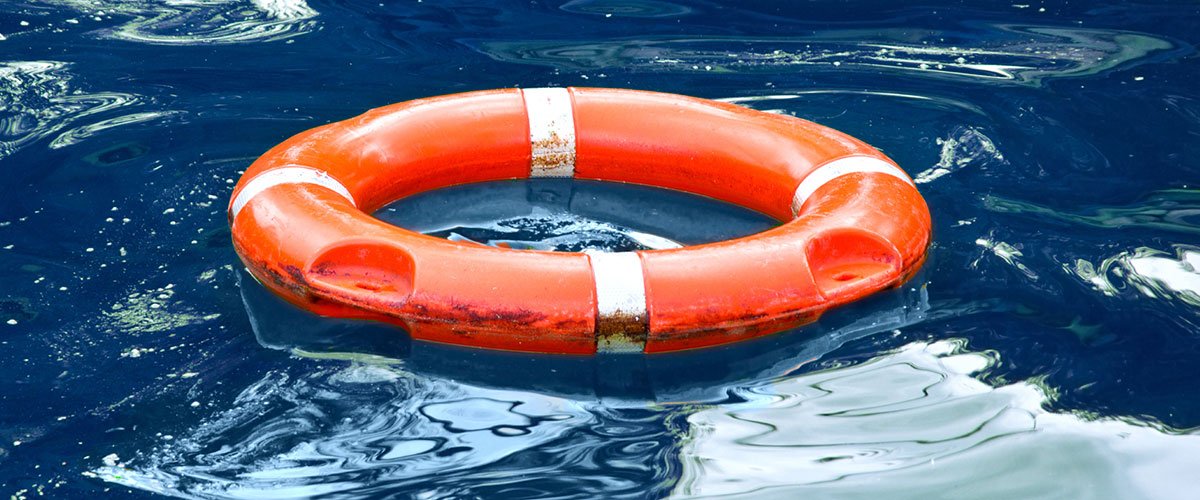 An orange buoy floating in blue water