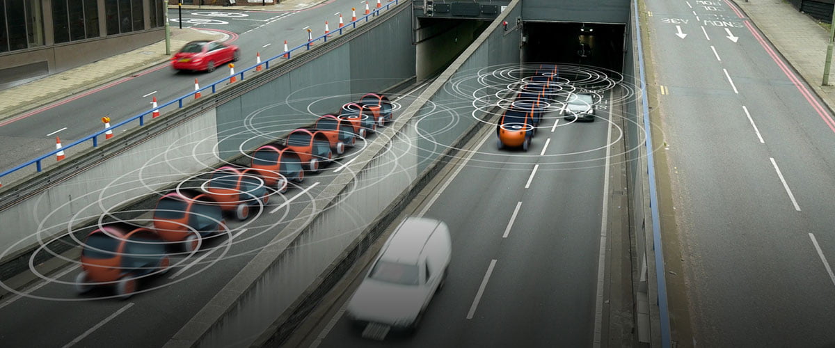 futuristic view of robotic cars on a road going under a tunnel