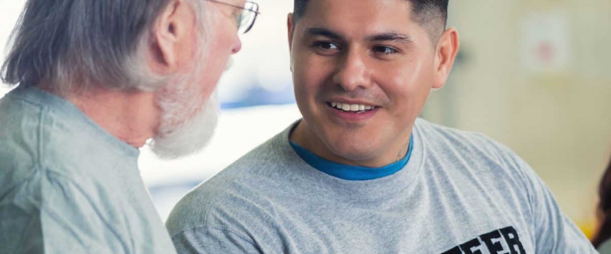 A picture of a young man keeping an older gentleman company