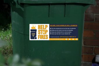 wheelie bin with help to stop fires sticker