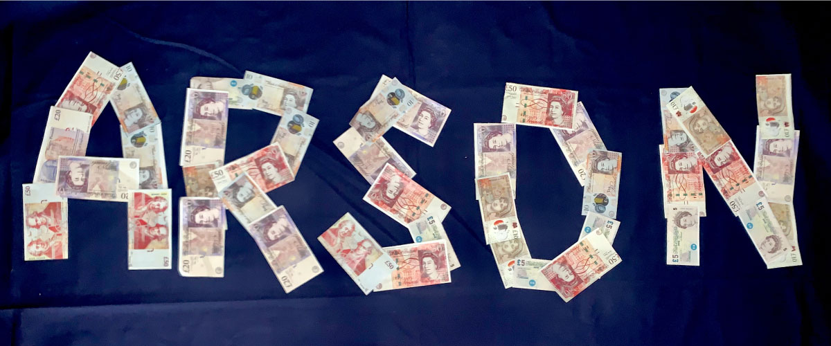 English bank notes arranged to spell arson