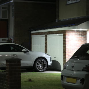 vehicles on a driveway outside a house