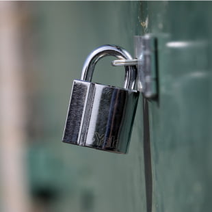 silver padlock on a door