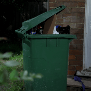 overflowing wheelie bin outside property
