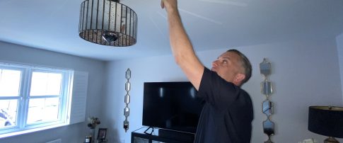 Home Safety Officer testing smoke alarm during a Safer Homes visit