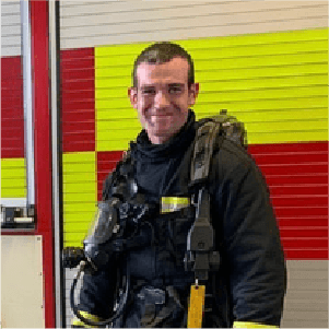 tim taylor on call fire fighter stood infront of fire engine