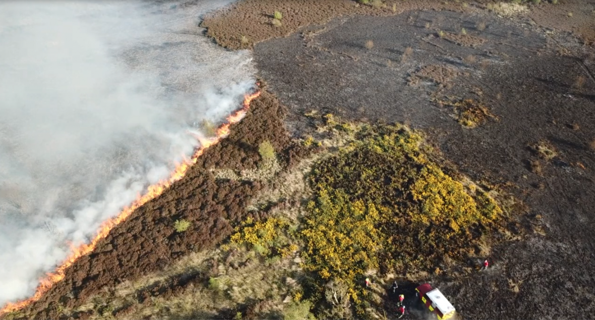 aerial drone shot of a grass fire on the hills in cleveland