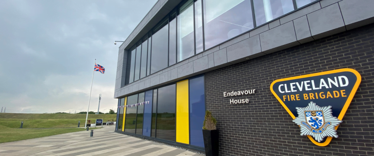 outdoor picture of endeavour house building with queens jubilee buntin and british flag flying in background