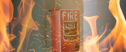 red fire alarm with flames covering it
