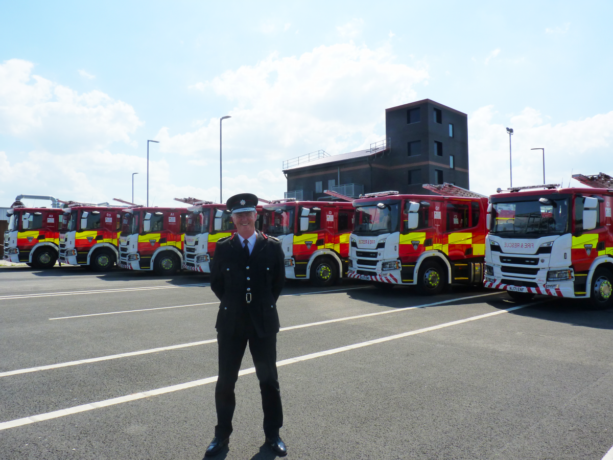 CFO, Ian Hayton stood in front of the seven new fire engines
