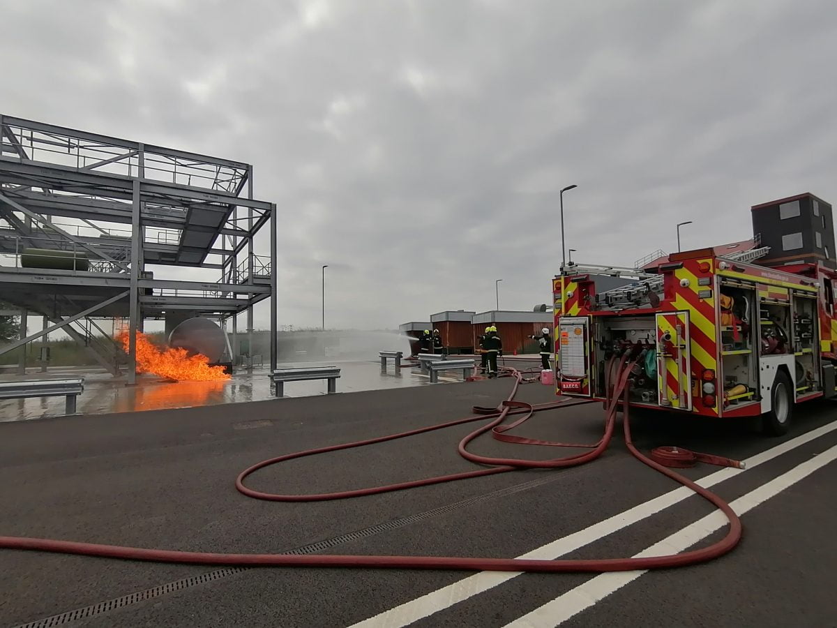 Fireground training with fire, firefighters and fire engine.