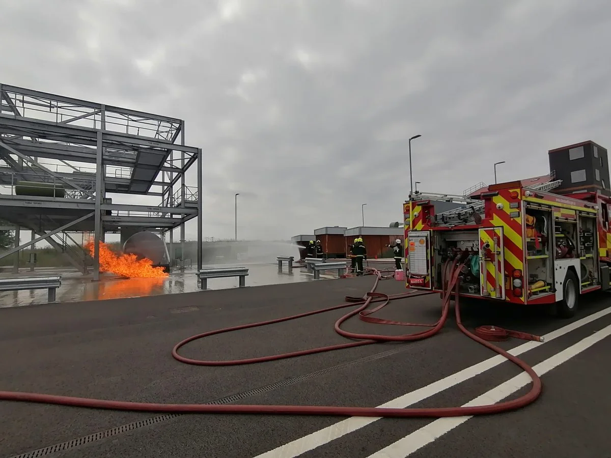 Fireground training with fire, firefighters and fire engine.