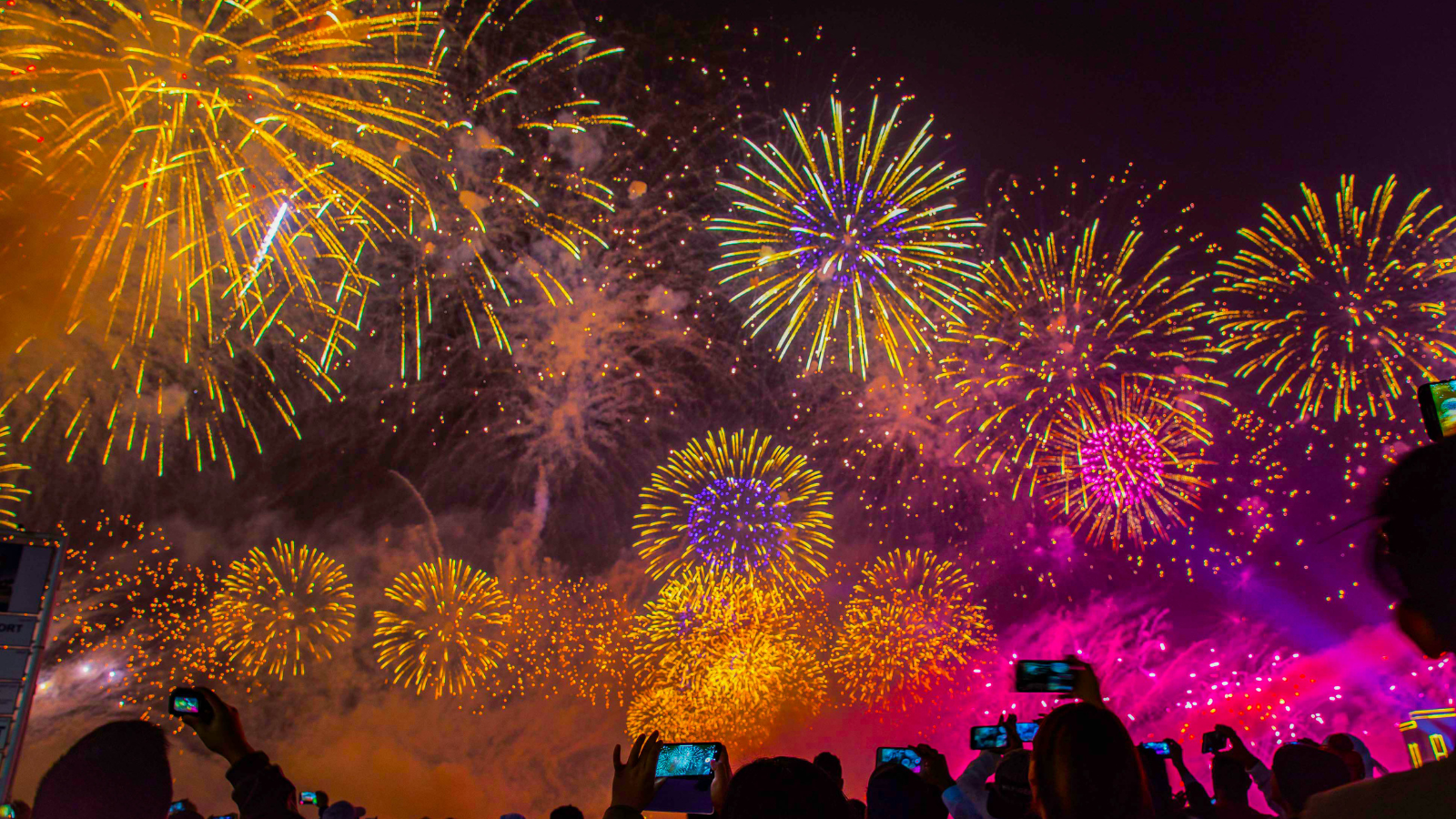 Colourful sky with fireworks lighting it up contrasts of orange yellow pink and purple