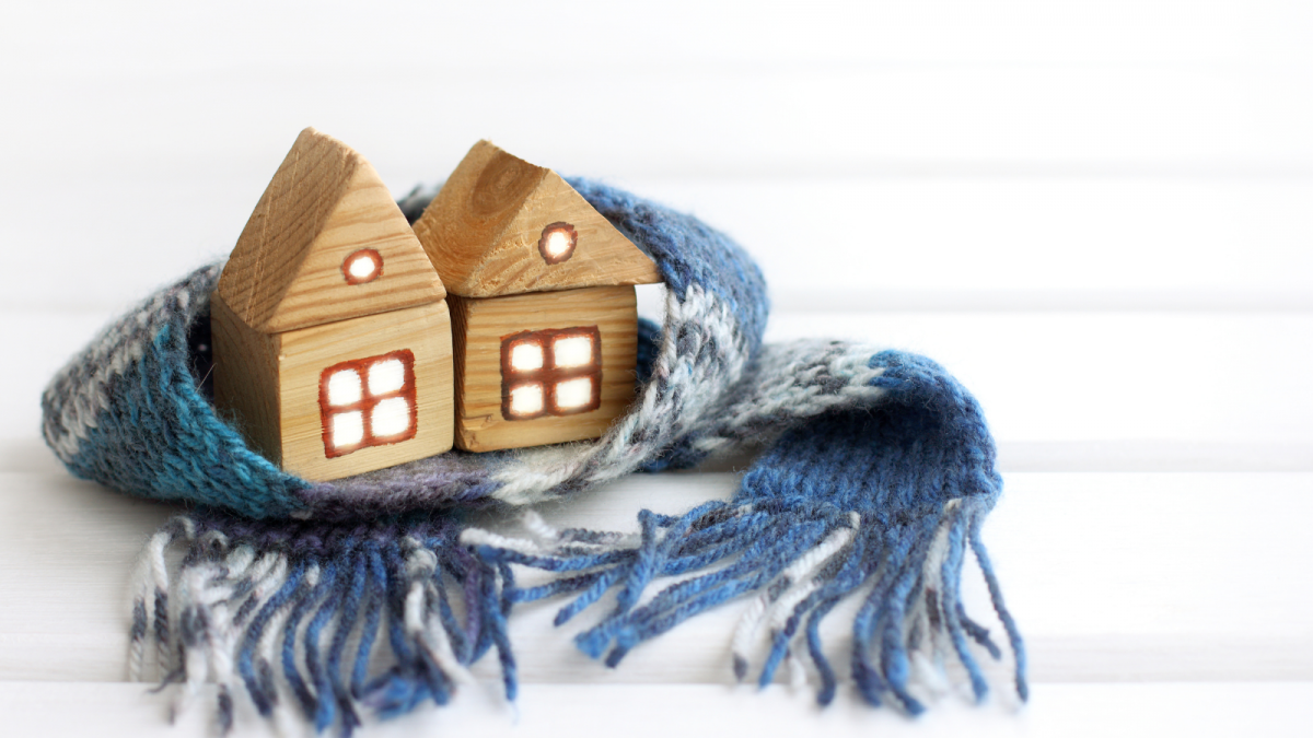 Picture of two wooden homes together with a scarf around them