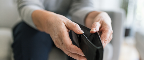 A person holding a empty wallet with no money or cards in