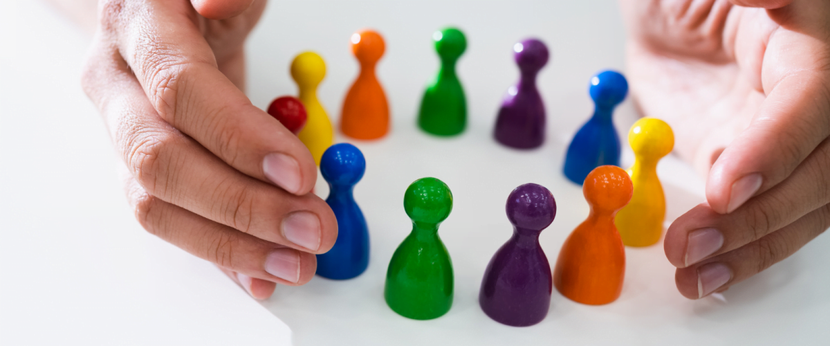 a pair of hands with colourful pieces in a circle