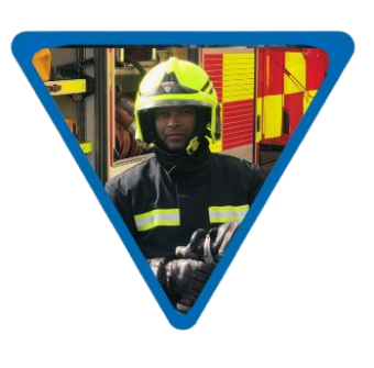 male firefighter with helmet and uniform stood infront of a fire engine