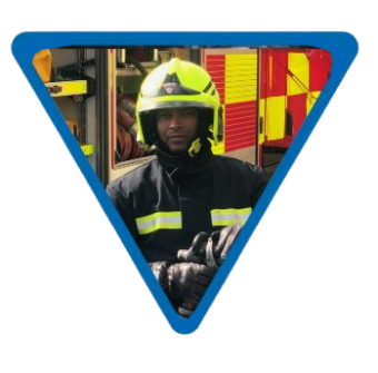 male firefighter with helmet and uniform stood infront of a fire engine