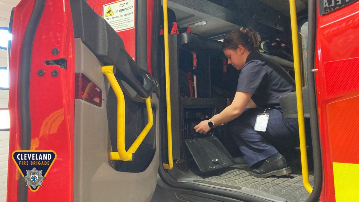 A picture showing a lady inside a fire engine updating the MDT system