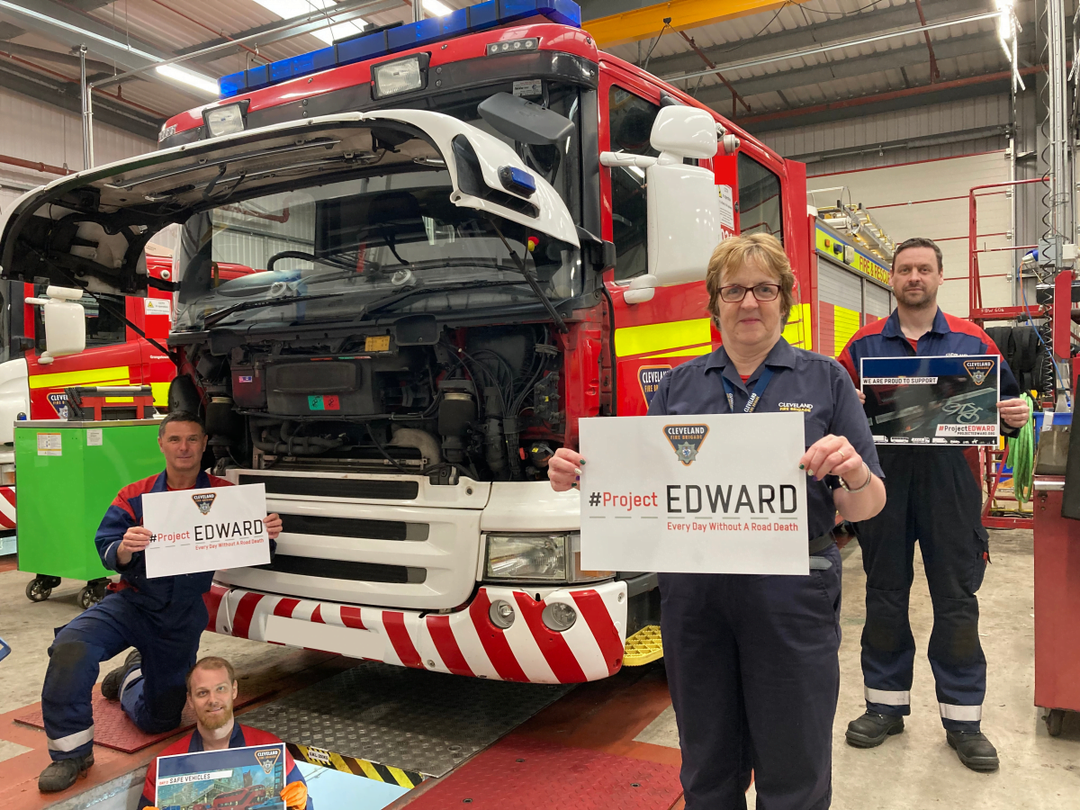 members of staff holding up a sign which says project edward