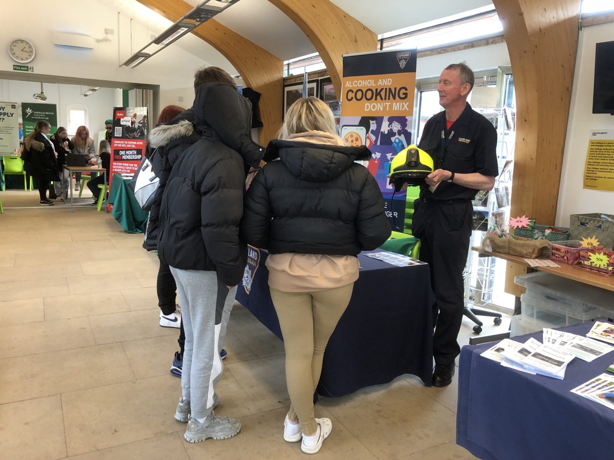 A group of students at a careers fair talking to a member of Brigade staff