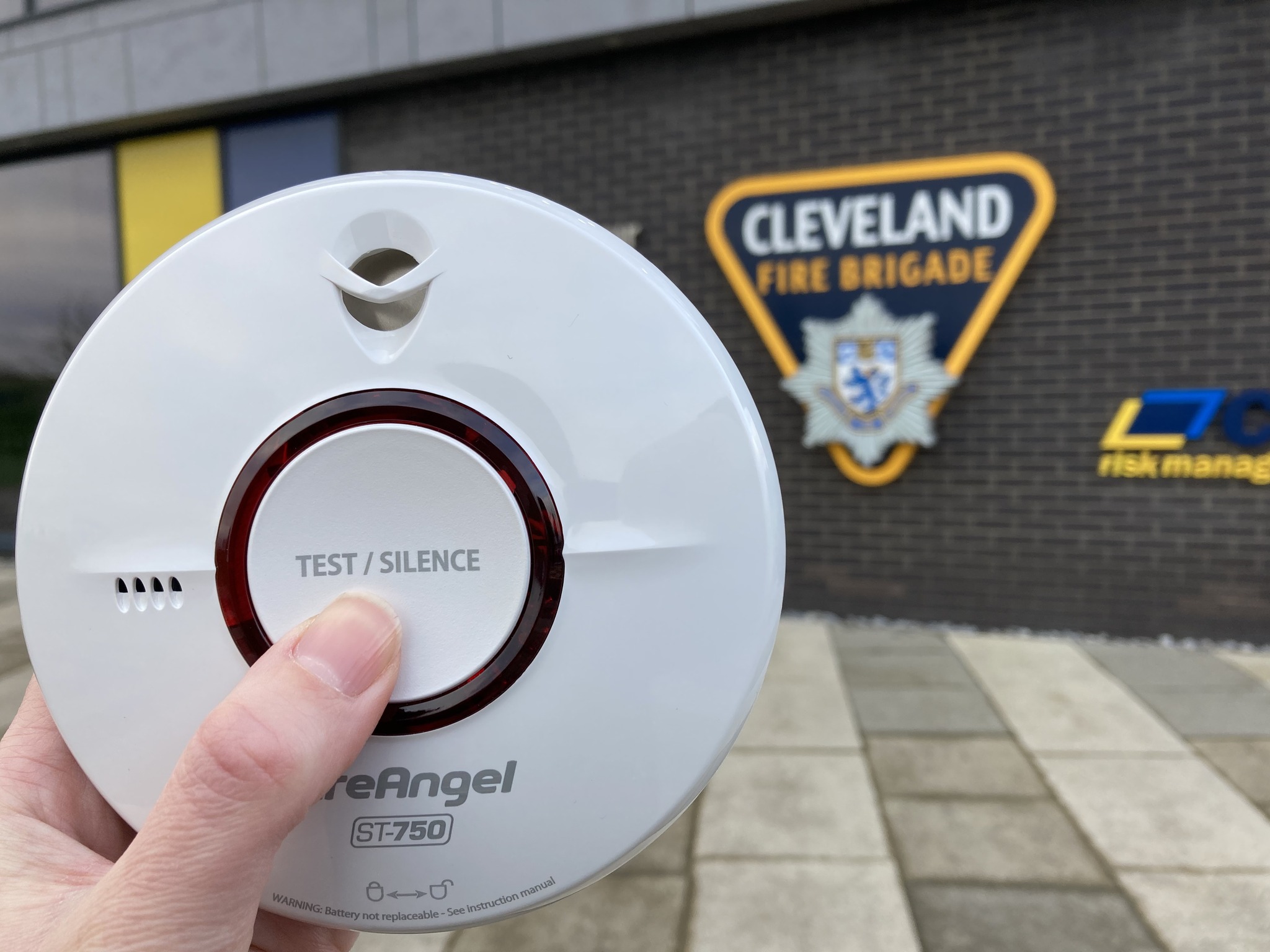 FireAngel smoke alarm with the test it button pressed outside of headquarters