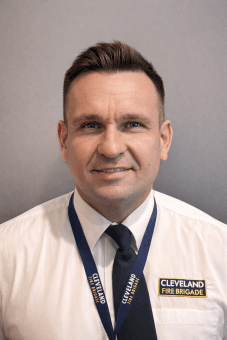 A headshot of Dave Preston in Brigade uniform smiling at camera.